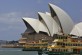 Ferries scuttle past the Opera House in Sydney Harbour