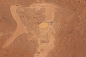 A mustering station and dam in the middle of the outback