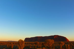 Sunrise over the rock, with the Olgas in the distance