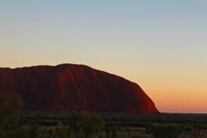 The first morning blush in the sky and on the end of Uluru