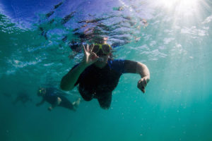 Happily snorkelling with Geoff in the background